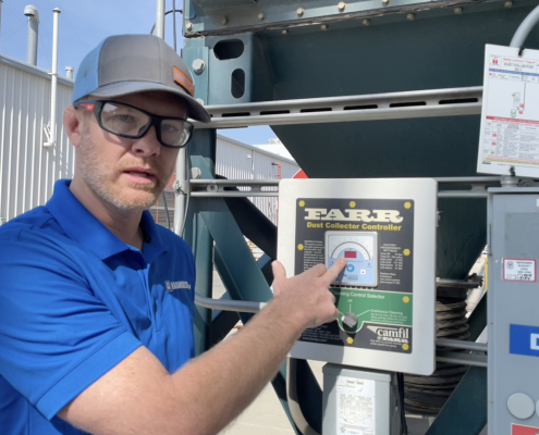 Baghouse personnel checking differential pressure in a baghouse